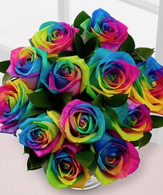 a bouquet of multicolored roses in a glass vase