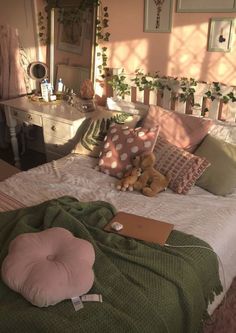 a bed with pillows and stuffed animals on it