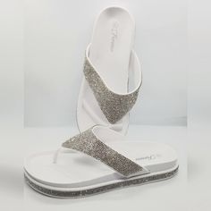 Rhinestone Embellished Thong Sandal Spring Rhinestone Synthetic Flip Flops, White Synthetic Sandals With Rhinestones, Bedazzled Sandals For Summer Beach, Bedazzled Sandals For Beach In Summer, Summer Bedazzled Sandals For Beach, White Sandals With Rhinestones And Adjustable Fit, White Rhinestone Sandals For Vacation, Bedazzled Synthetic Sandals For Summer, White Rhinestone Sandals For Summer