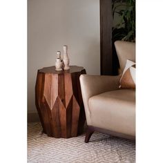 two vases are sitting on top of a wooden table in front of a chair