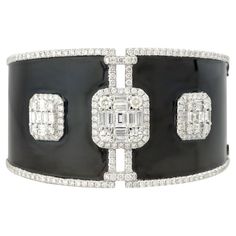 18k White Gold 7.03ctw Diamond Mosaic and Black Enamel Wide Cuff Bracelet Style: Women's Diamond Enamel Cuff Bracelet Material: 18k White Gold and Enamel Main Diamond Details: Approximately 7.03ctw of Mosaic set, Baguette and Round Brilliant Cut Diamonds Bracelet Size: Bracelet will fit a 7" wrist Item Weight: 53.6g (34.4dwt) Additional Details: This item comes with a presentation box! SKU: A30316077 Wide Cuff Bracelets, Diamond Mosaic, Bracelet Style, Wide Cuff, Women Diamond, Round Brilliant Cut Diamond, Black Enamel, Bracelet Sizes, Karate