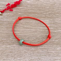 Red String Green Jade Bracelet Mens Surfer Bracelet Waterproof Unisex Good Luck Wish Amulet Bracelet Beach Bracelet Christmas Gift For Dad 【About this item】 ❤ This bracelet is made of 1.5mm waxed cord and a natural green jade donut. The jade donut is a grade A jade, comes from Burma. ❤ This bracelet is adjustable. It will fit wrist size from 5.5 inches to 8 inches. To adjust slide knots to your perfect size. ❤ According to MY TESTING, this bracelet can be worn for a long time, You don't even hav Spiritual Red Stretch Bracelet As Gift, Spiritual Red Stretch Bracelet Gift, Adjustable Red Charm Bracelet, Adjustable Red Round Charm Bracelet, Adjustable Round Red Charm Bracelet, Casual Red Charm Bracelet Gift, Red Spiritual Friendship Bracelets For Beach, Adjustable Red Stretch Bracelet For The Beach, Adjustable Red Stretch Bracelet For Beach