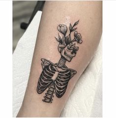 a skeleton with flowers on its head and arm