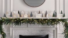 a mantel decorated with christmas trees and lit candles