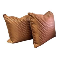 two brown pillows sitting next to each other