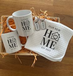 two coffee mugs in a gift box with personalized towels