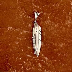 Ray Tracey, Navajo feather and corn pendant.  Ray Tracey is a legendary Navajo artist.  DETAILS: Created by Navajo artist, Ray Tracey Sizes: 2 3/4" long x 5/8" wide - weight: 8.0 grams Ray Tracey Jewelry, Halloween Shopping, Corn, Created By, Electronic Accessories, Ships, Purses And Bags, Music Clothes, Pendant