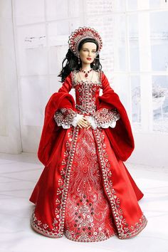 a doll is dressed in red and white