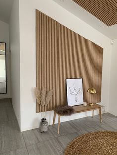 a room with a wooden paneled wall next to a rug and table in front of it