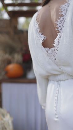 the back of a woman's white wedding dress