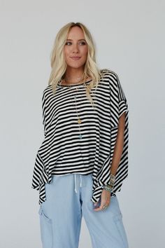 You'll feel laid back and cool all day long in the boho - chic French Riviera Striped Top, so effortless it's sure to be your new fav top to style from day to night! ! Comfortable tee shirt fabric with a cute striped design Loose and slouchy pullover top silhouette Classic round neckline and loose short sleeves with a contrast hem Boxy design that creates the ultimate boho slouchy style Back pointed panel for an added design element Pair with: Eye Of The Sun Padded Bralette, Sardinia Silky Tiere Flowy Short Sleeve Tops For Loungewear, Oversized Black Bohemian Top, Spring Bohemian Loungewear Tops, Bohemian Relaxed Fit Top For Loungewear, Long Sleeve Boho Top For Vacation, Bohemian Loungewear Top With Relaxed Fit, Free-spirited Long Sleeve Vacation Tops, Summer Loungewear Top With Shirttail Hem, Bohemian Short Sleeve Tops For Loungewear