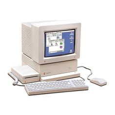 an old desktop computer sitting on top of a white table next to a keyboard and mouse