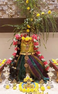 a statue with flowers and other decorations around it