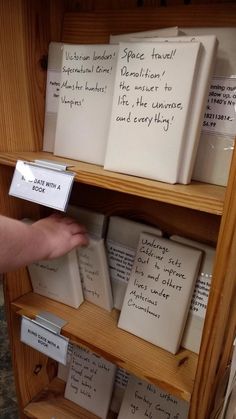 a book shelf filled with lots of books and writing on the front pages that are written in different languages