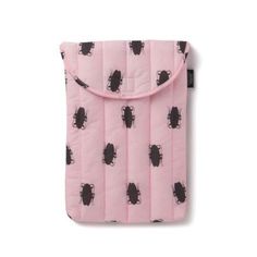 a pink bag with black bugs on it