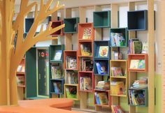 the children's bookshelves are lined up against the wall in the library