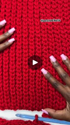 two hands with pink and white manies on their nails, one holding a crochet hook