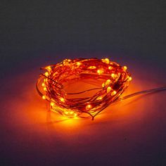 a string of orange lights sitting on top of a table