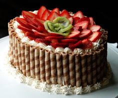 a cake with strawberries and kiwi on top