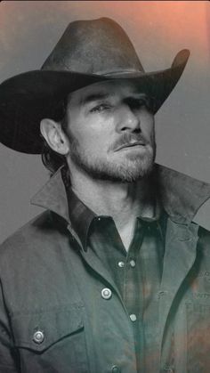 a black and white photo of a man in a cowboy hat looking off to the side