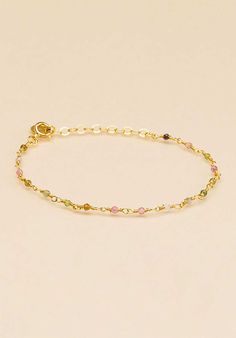 Vibrant in colour, this Tourmaline Beaded Gold Plated Bracelet from UNE A UNE is crafted from tourmaline beads colours and separated by gold-plated chain. It is finished with a logo-engraved charm and can be easily adjusted for the perfect fit. Slip it on and stack it high. Gold Spiritual Beaded Chain Bracelet, Gold Tourmaline Gemstone Bracelets, Gold Tourmaline Bracelet Jewelry, Gold Tourmaline Bracelet, Elegant Gold Tourmaline Bracelets, Dainty Gold Tourmaline Jewelry, Beaded Tourmaline Bracelets As A Gift, It Is Finished, Tourmaline Beads