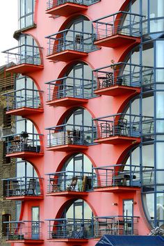 an orange building with many balconies on it