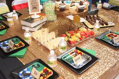 a table topped with lots of food and desserts