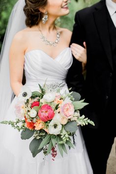 a bride and groom standing next to each other