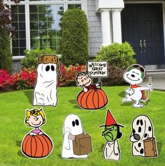 halloween yard decorations with ghost, pumpkins and jack - o'- lanterns in front of a house