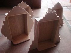 three wooden shelves sitting on top of a floor next to each other in front of a door