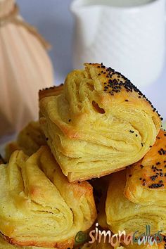 a pile of pastries sitting on top of a white plate next to a pumpkin