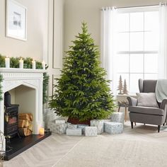 a living room with a christmas tree in the corner