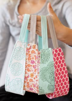 a woman holding four small bags with the words fabric headband in front of her