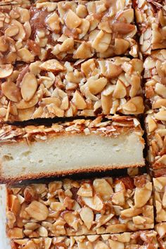 a close up of sliced cake with nuts on top