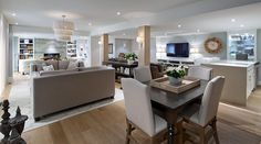 a living room filled with furniture and a flat screen tv on top of a wooden table