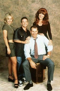 a family posing for a photo in front of a wall