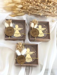 three brown boxes with angel tags on them