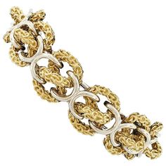 Here we have an outstanding, vintage, 3D infinity knot link bracelet that was crafted in Italy from solid 18k yellow and white gold. The bracelet's yellow gold infinity knots are intricately textured and are neatly connected with polished thick white gold wires. The chain measures 18.65mm wide, rises 11.91mm off the wrist, and closes with a super secure box clasp and fold-under through-pin safety latch. This magnificent vintage bracelet is a true statement piece and remains in excellent ready to Luxury Yellow Single Strand Jewelry, Infinity Knot, Box Clasp, Vintage Bracelet, Gold Wire, Horse Head, Vintage Bracelets, Vintage Italian, Chain Lengths