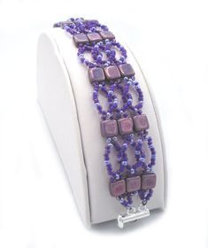 "LILAC LUSTER TILE Hand Beaded Bracelet Woven Bracelet Handmade Purple Beaded Bracelet 7.0\" Lovely Time and patience goes into making bracelets of this type, but in the end it is very well worth it. Gorgeous Lilac Luster square tiles alternating with intertwining rows of two tone purple seed beads neatly woven together.  Bracelet is reinforced throughout with Fire Line thread and finally, a silver silde clasp is firmly attached to the bracelet. A really lovely bracelet. Bracelet length: 7.0\" x Purple Tile, Time And Patience, Purple Beaded Bracelets, Square Tiles, Making Bracelets, Purple Beaded, Woven Bracelet, Beaded Jewellery, Woven Bracelets