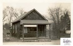 an old black and white photo of a small building