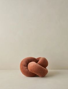 a round pillow sitting on top of a white table