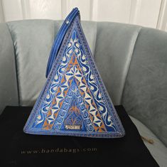 Nwot Banda Bag Pyramid Clutch Purse Made In Sumatra Indonesia 12 In Tall By 9 In Wide Comes With The Dust Bag Shown Head Turning Eye Catching One Of A Kind Bag Sold Out On The Website Banda Bags, Bag Ideas, Blue Bags, Clutch Purse, Metal Decor, Pyramid, Blue Gold, Turning, Dust Bag