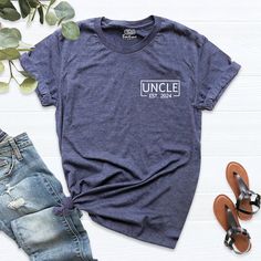 a t - shirt with the words uncle on it next to some shoes and sunglasses