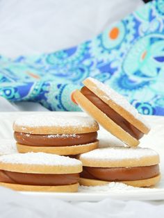 some sugar covered donuts on a white plate