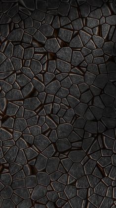 an abstract black and brown textured background with lots of small cracks in the middle