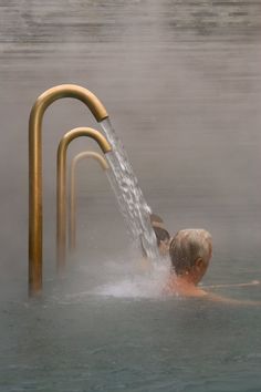 a man swimming in the water with a hose attached to it