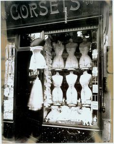 an old fashion store front with mannequins in the window