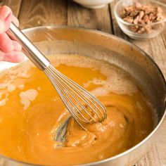 a person whisk some food in a pan