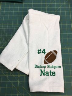 a white towel with a football embroidered on it