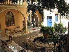 an outdoor courtyard with tables and chairs